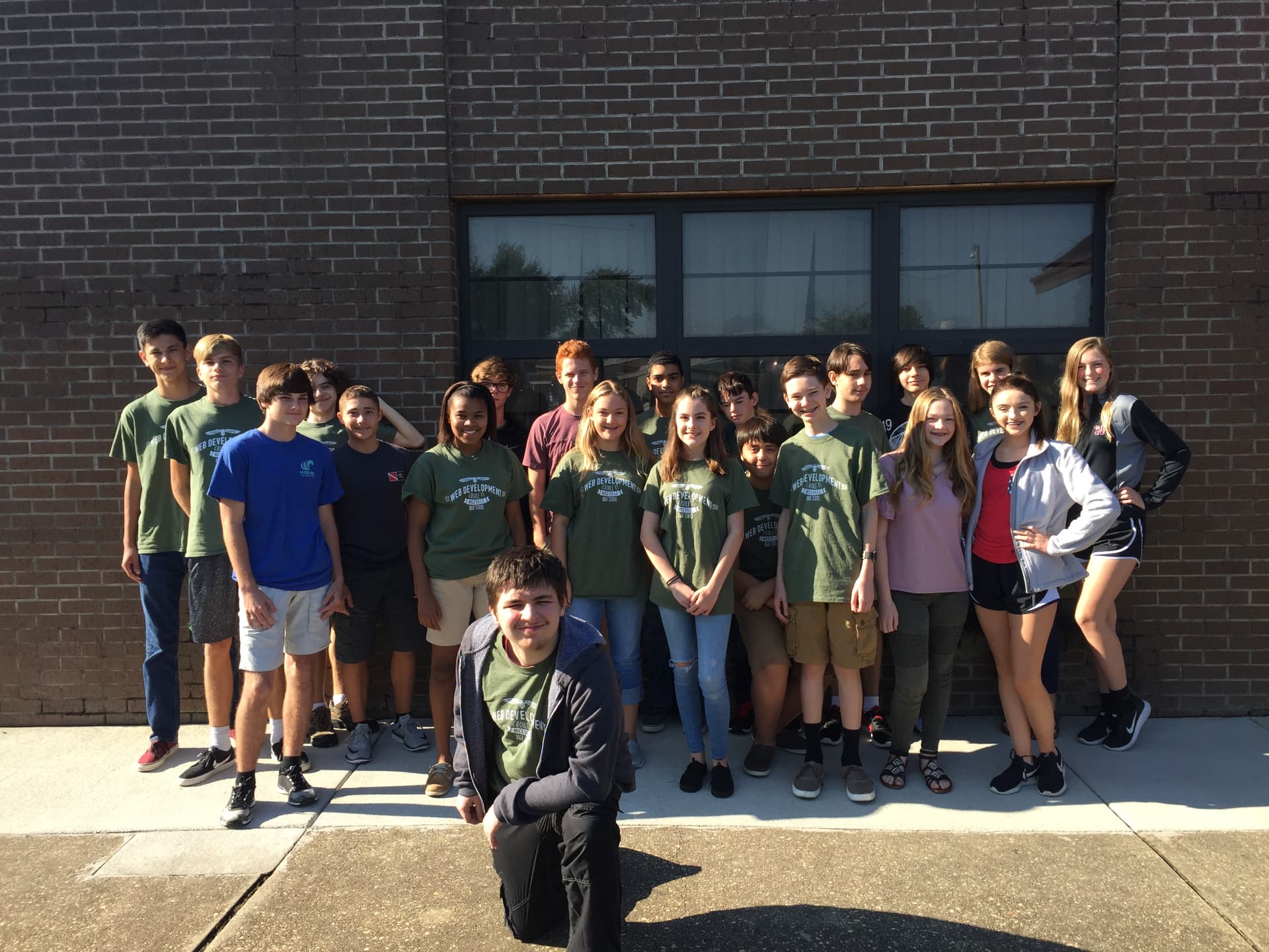 Students in program shirts posing as a class