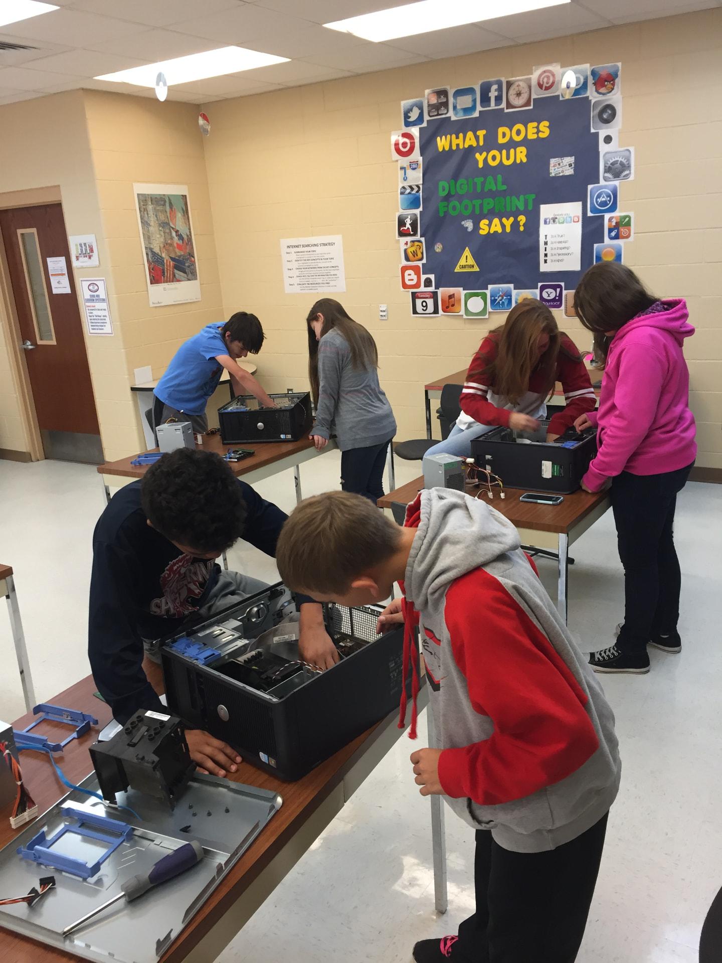 Students building and repairing computers in class