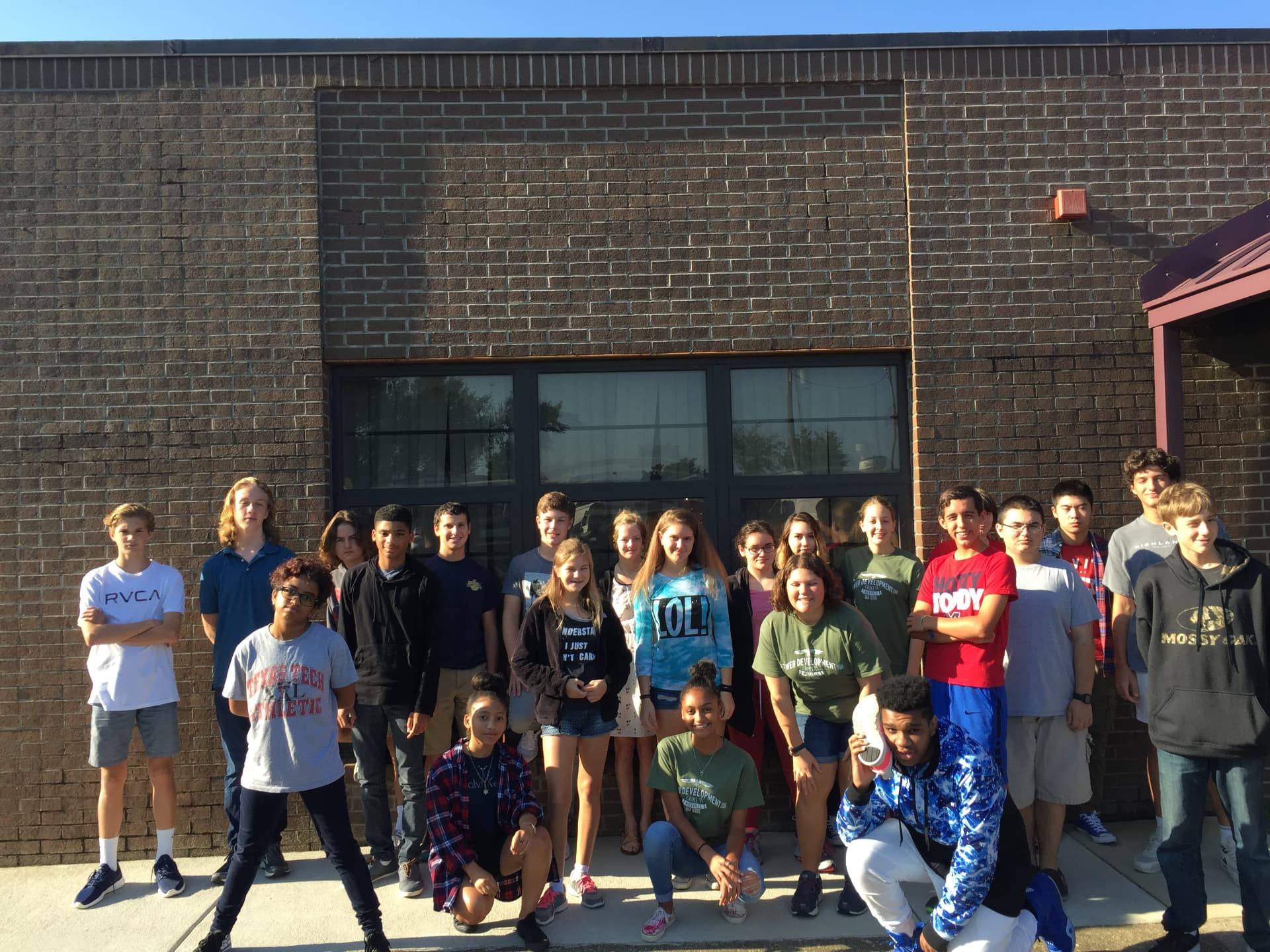 A student group outside the school building