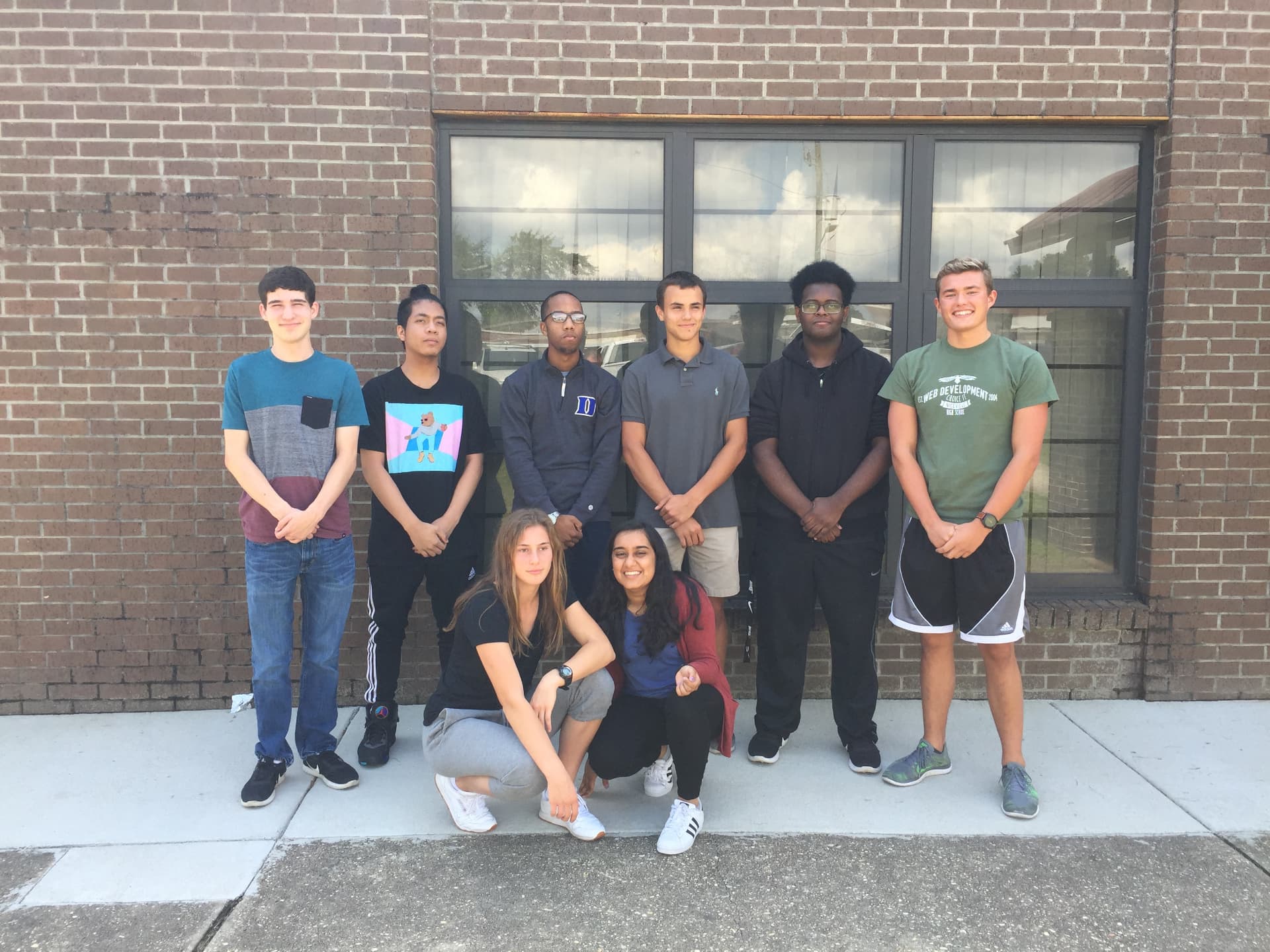 A small cohort of students standing together